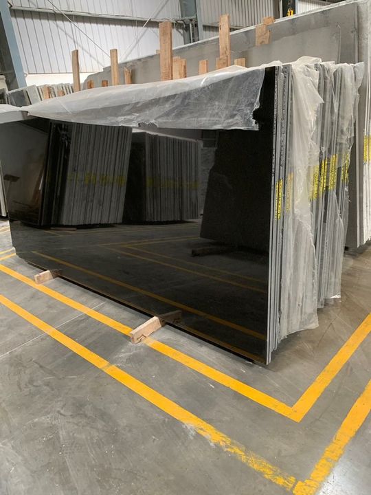 Stack of polished jet-black granite slabs