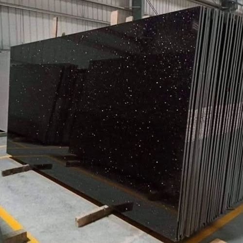 Polished black granite slabs with gold flecks in our yard