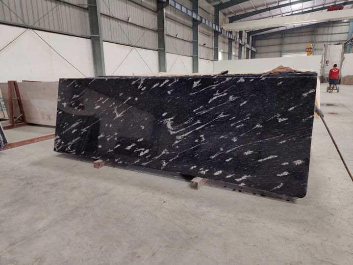 Black granite slab with bold white wave veins