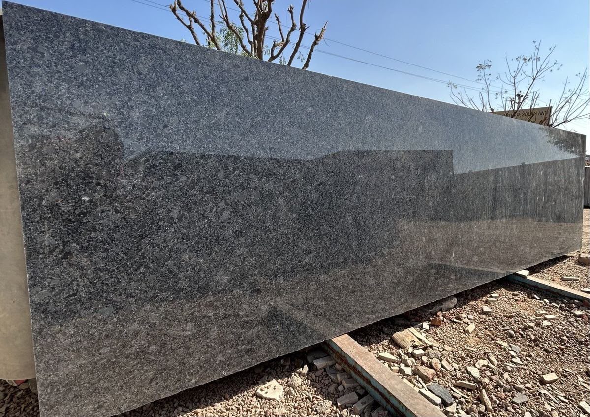 Polished grey speckled granite slab outdoors